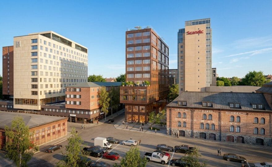 Flera höghus vid kajen i Umeå en solig dag
